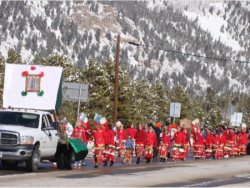 Procession with the Missionary Image of Our Lady of Guadalupe led by a priest to the top of a mountain in Monument, CO.